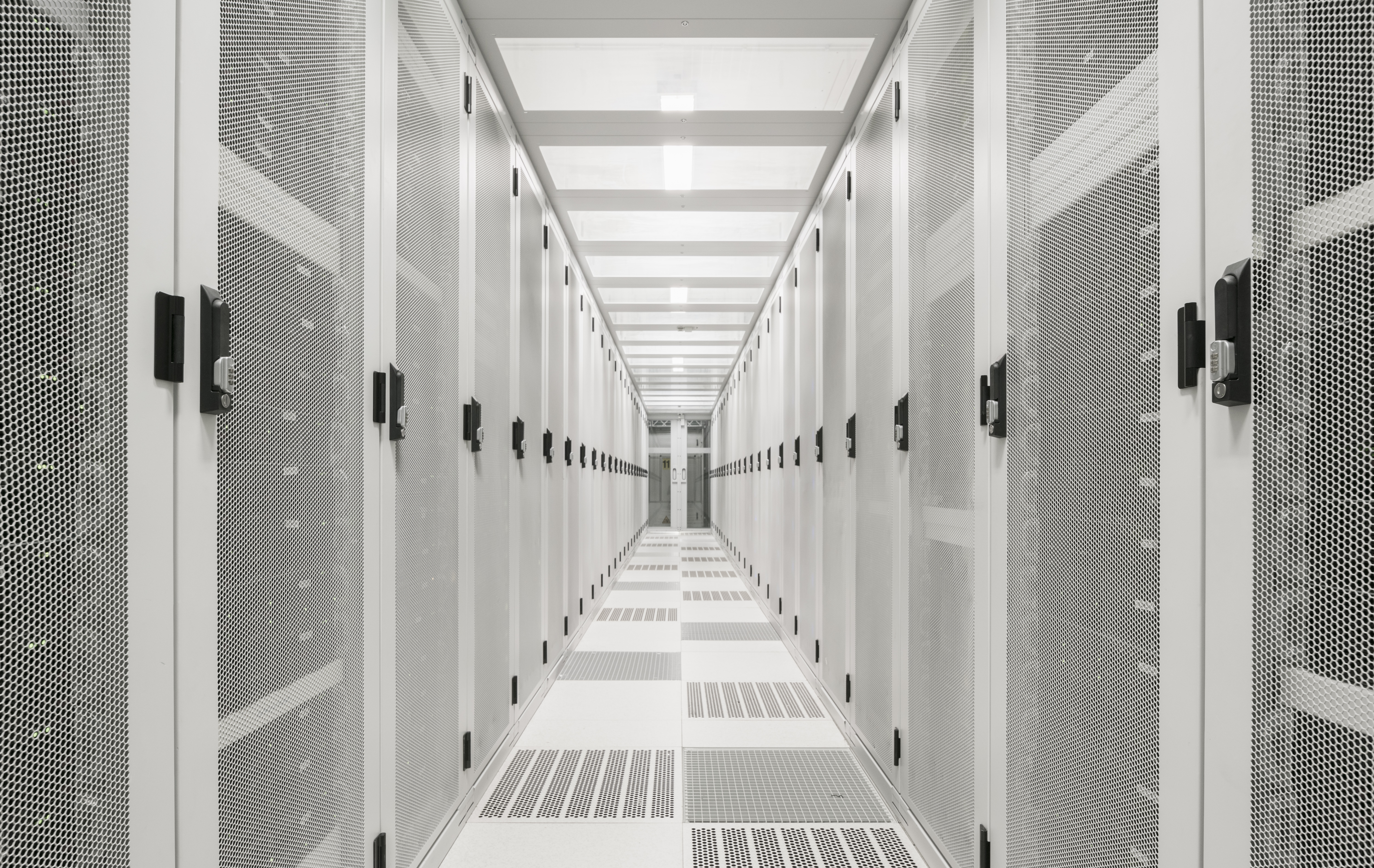 A serene and modern atmosphere of a data center interior with white neutral colors
